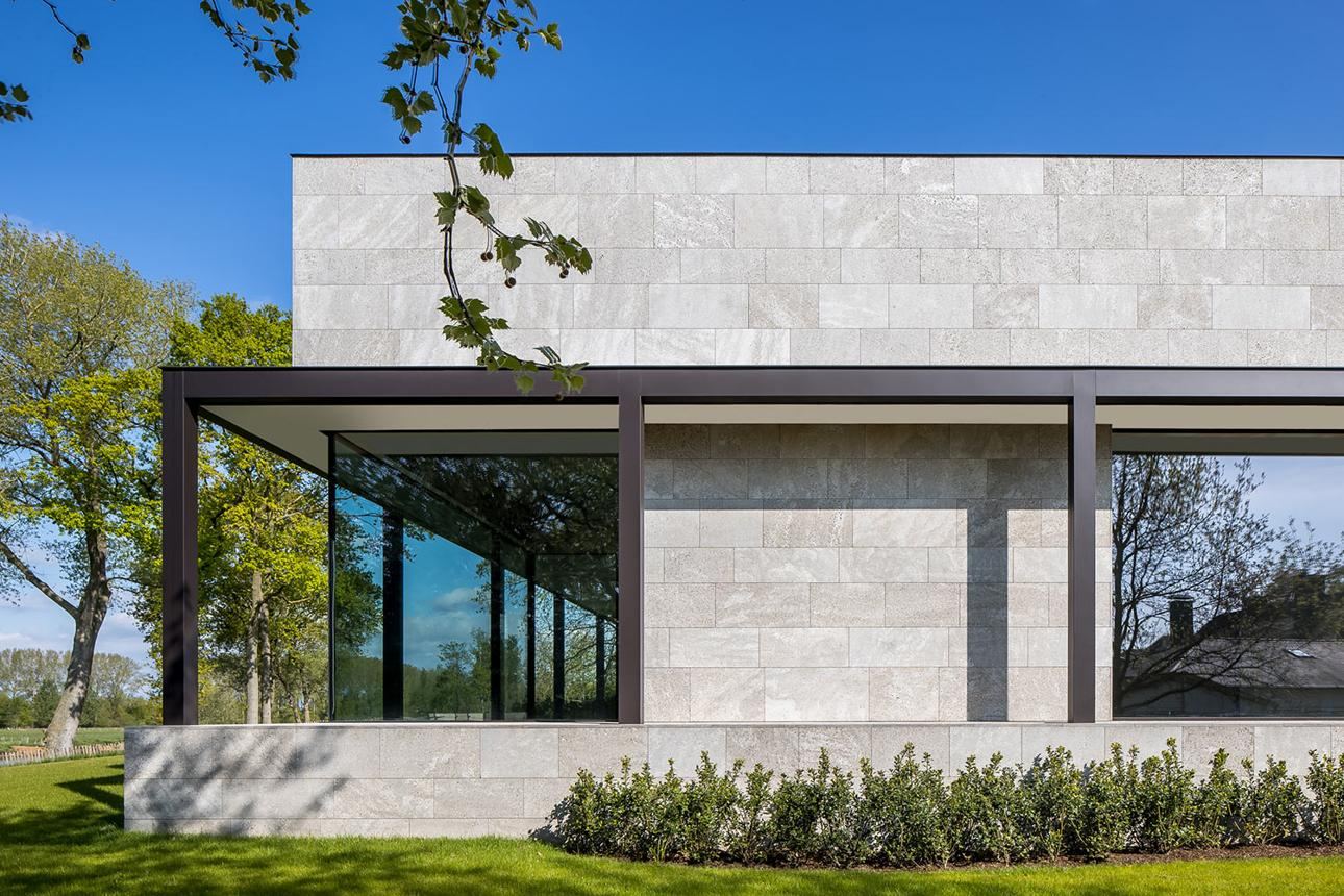 Stone-clad pavilion with slim black frames